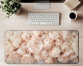 May include: A rectangular desk mat with a close-up of soft, blush-coloured peonies. The floral design is detailed and fills the entire mat, creating a visually appealing and elegant workspace accessory.
