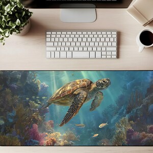 May include: A rectangular desk mat with a detailed illustration of a sea turtle swimming in a vibrant coral reef. The mat has a black border and is surrounded by a keyboard, monitor, and other office supplies.