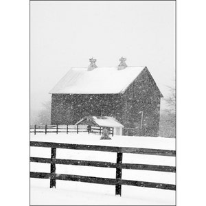 Rural Wood Barn and Farm Pasture Fence during Winter Snowstorm in Cascade Michigan A Black and White Fine Art Landscape Photograph