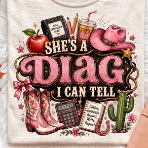 May include: A cream-colored t-shirt featuring a graphic print with the text 'SHE'S A DIAG I CAN TELL'. The design includes a red apple, a pink cowboy hat, pink floral cowboy boots, a calculator, a cactus, a notebook, and a drink with a straw.