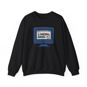 May include: Black crew neck sweatshirt with a blue retro computer screen graphic. The screen shows the word "LOADING" with a progress bar and a cursor. The sweatshirt is made of a soft material and is suitable for casual wear.
