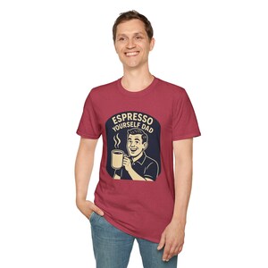 May include: Maroon t-shirt with the text "Espresso Yourself Dad" in a navy blue oval. The graphic features a smiling man holding a coffee mug. The shirt is made of a soft material and is suitable for casual wear.