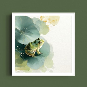 May include: Watercolor painting of a green frog on a lily pad. The frog has a green and yellow body with dark green stripes. The lily pad is a mix of green and blue hues, with gold accents. The artwork is framed in a white square frame.