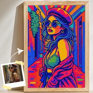 May include: A colourful pop art print of a woman wearing a red beret and sunglasses, framed in natural wood. The artwork uses bold colours, including blue, yellow, and pink, creating a striking visual effect. The woman is depicted in a stylish outfit.