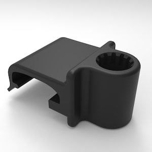 May include: A black plastic car cup holder with a rectangular top and a cylindrical cup holder. The cup holder has a ridged interior. The item is designed to attach to a car's interior.