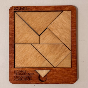 May include: Wooden puzzle with the text "SQUARE +" at the top. The puzzle has a dark brown frame and light brown pieces. The text "FIT SMALL TRIANGLE INTO CUTOUT WITH OTHER PIECES" is at the bottom. The puzzle pieces are various geometric shapes.