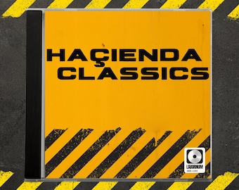 May include: A CD case featuring a bright yellow cover with the words "HACIENDA CLASSICS" in bold black letters. The cover has black diagonal stripes and a small logo in the bottom right corner. The case is on a gray surface with yellow and black diagonal stripes.