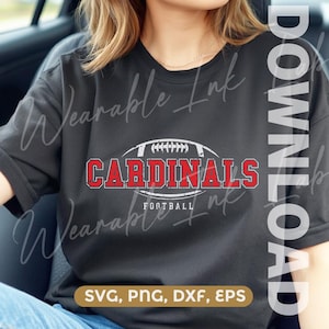 May include: A black short-sleeved t-shirt featuring a distressed white and red graphic of a football with the text Cardinals Football across the centre. The design has a weathered texture and is positioned on the chest of the garment.