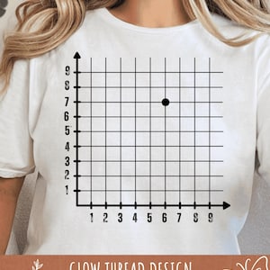 May include: White t-shirt featuring a black grid with numbered axes and a black dot at coordinate (6,7). The text "GLOW THREAD DESIGN" is printed in brown at the bottom of the shirt. The shirt is a casual, everyday wear item.