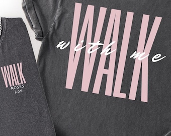 Puede incluir: Dos camisetas gris carbón con la palabra "WALK" en letras rosas. Una camiseta tiene "WALK" en la parte delantera con "MOSES 6:34" debajo. La otra camiseta tiene "WALK with me" en la espalda. Una cadena de plata está en una camiseta.