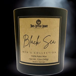 May include: Black candle jar with a brown label that reads "THIS LITTLE LIGHT CANDLES Black Sea MEN'S COLLECTION 100% Palm Wax Net Wt. 12oz (340g) Made in Georgia"