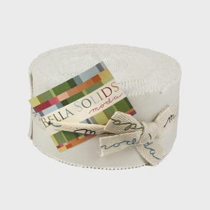 May include: A roll of white fabric with a tag that reads "BELLA SOLIDS moda." The tag has a colorful geometric design. A cream-colored ribbon is tied around the fabric roll with the word "moda" printed on it.