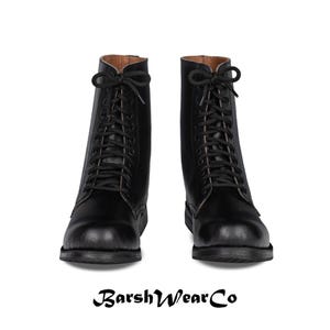May include: A pair of black leather combat boots with black laces. The boots have a rounded toe and a sturdy sole. The brand name "BarshWearCo" is printed at the bottom of the image.