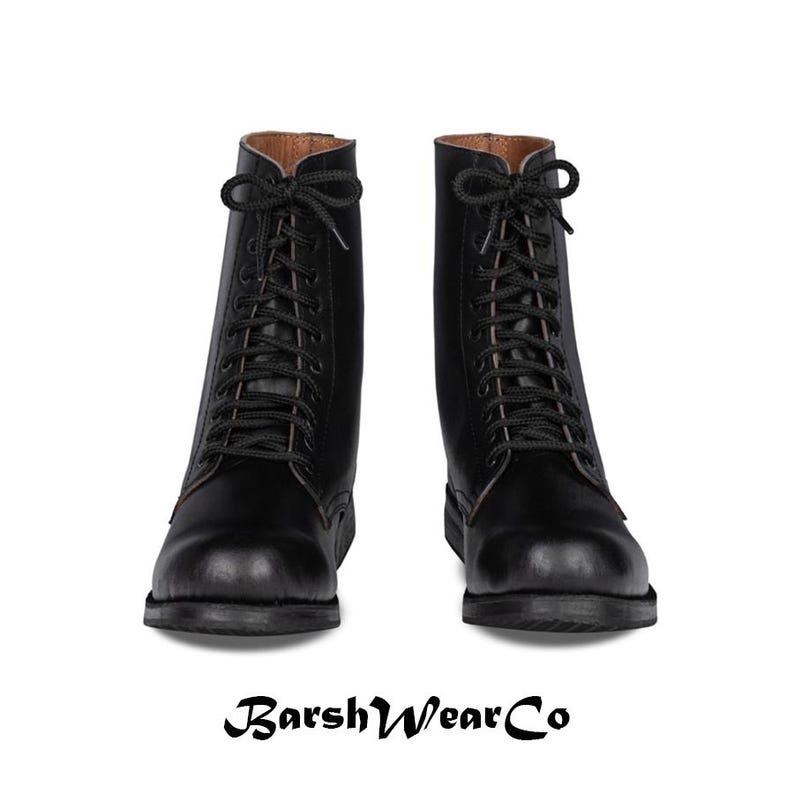 May include: A pair of black leather combat boots with black laces. The boots have a rounded toe and a sturdy sole. The brand name "BarshWearCo" is printed at the bottom of the image.