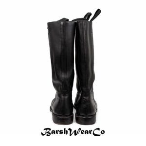 May include: A pair of black leather riding boots. The boots are tall, with a smooth finish and a pull tab at the top. The soles are dark, and the boots are set against a white background. The brand name "BarshWearCo" is at the bottom.
