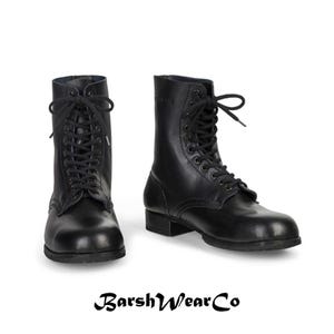 May include: Two black leather combat boots with lace-up closures. The boots have a mid-calf height and a sturdy sole. The brand name "BarshWearCo" is displayed at the bottom of the image.