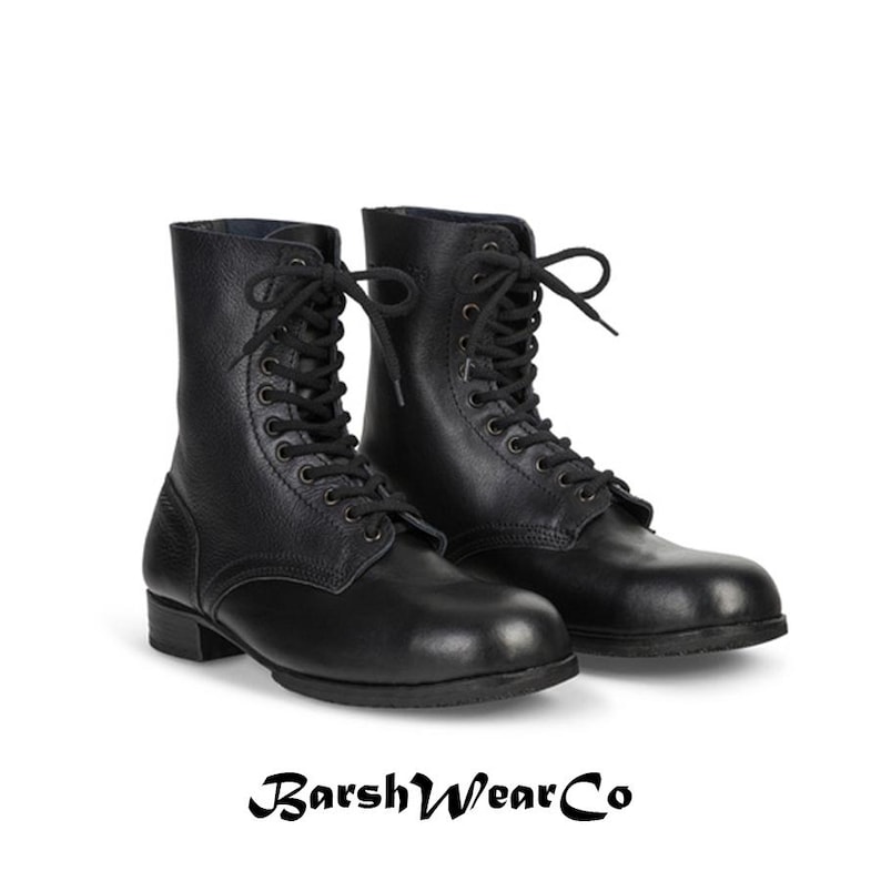 May include: A pair of black leather combat boots with a lace-up design. The boots have a rounded toe and a low heel. The brand name "BarshWearCo" is printed in a stylized font at the bottom of the image.