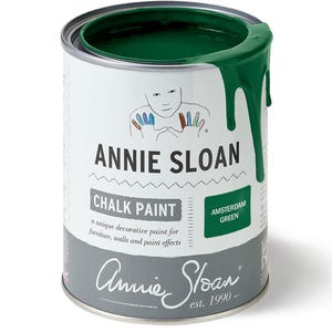 May include: A can of Annie Sloan Chalk Paint in Amsterdam Green. The can is white with a gray band at the bottom and features the brand name and product description. The paint is a vibrant green, with some dripping down the side.