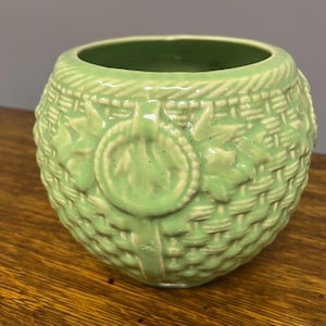 May include: A set of three ceramic mugs with a speckled, matte finish. The mugs are in shades of cream, light gray, and dark gray. Each mug has a simple, minimalist design and a rounded handle.