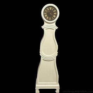 May include: A tall, off-white floor clock with a curved, hourglass-shaped body and a circular top section. The clock face is dark with gold-colored Roman numerals and two thin hands. The base is rectangular with four small, short feet at the bottom.