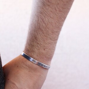 May include: A silver bracelet with the words "Be Brave" engraved on it.
