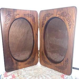 May include: A handmade, wooden serving tray with a natural finish. The tray features a rectangular shape with rounded corners and two carved handles. The wood grain is visible, adding to its rustic charm. Perfect for serving food or displaying items.