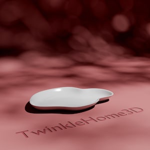 May include: A white, cloud-shaped ceramic serving dish. The dish has a smooth, glossy finish and sits on a pink surface. The text "TwinkleHome3D" is embossed on the surface. The background is a blurred maroon.