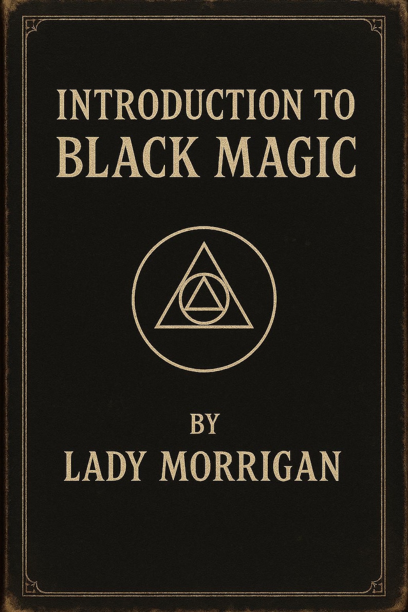May include: A black book cover with gold lettering that reads INTRODUCTION TO BLACK MAGIC BY LADY MORRIGAN. In the center is a gold circular emblem containing a triangle with a smaller triangle inside. The cover has a thin gold border frame.