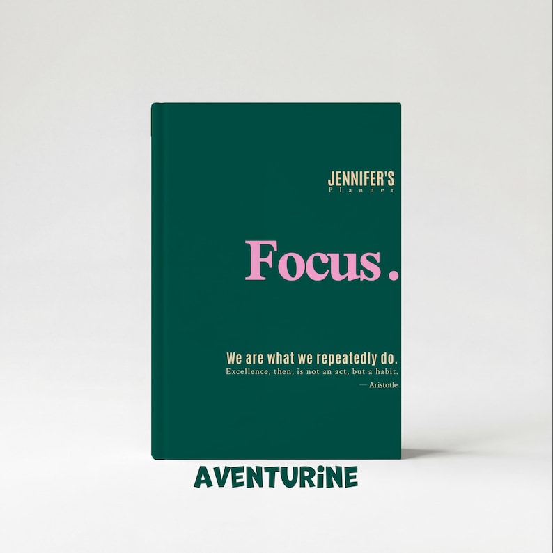 May include: A dark green planner with the text "JENNIFER'S Planner" at the top and the word "Focus." in pink. Below, it reads "We are what we repeatedly do." and "AVENTURINE" at the bottom.