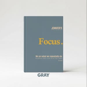 May include: Gray journal with the text "Focus." in gold lettering. The journal also includes the text "We are what we repeatedly do. Excellence, then, is not an act, but a habit. Aristotle." The word "GRAY" is at the bottom.