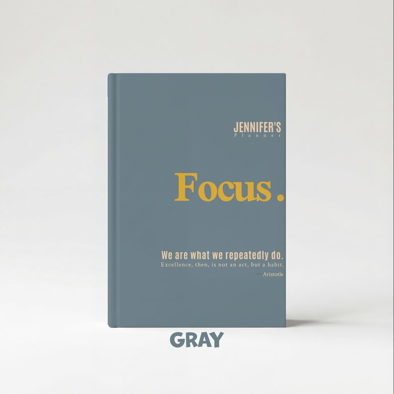 May include: Gray journal with the text "Focus." in gold lettering. The journal also includes the text "We are what we repeatedly do. Excellence, then, is not an act, but a habit. Aristotle." The word "GRAY" is at the bottom.