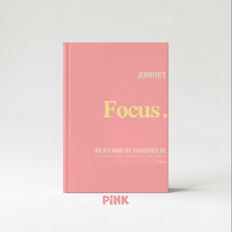 May include: A pink journal with the word "Focus" in yellow lettering. The journal also has the text "Jennifer's" at the top and a quote by Aristotle. The word "PINK" is at the bottom.