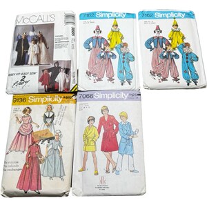 May include: A collection of vintage sewing patterns featuring various costume designs. The patterns include designs for children's costumes, such as clowns, historical outfits, and robes. The packaging is colorful, with illustrations of the finished garments.