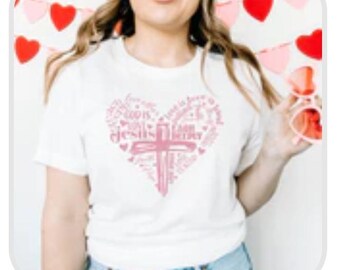 May include: White t-shirt with a pink heart design featuring a cross and the words "Love is patient, love is kind, love is not jealous, love is not boastful, love is not proud, love is not rude, love is not self-seeking, love is not easily angered, love keeps no record of wrongs, love does not delight in evil, but rejoices with the truth, love always protects, always trusts, always hopes, always perseveres. Love never fails."