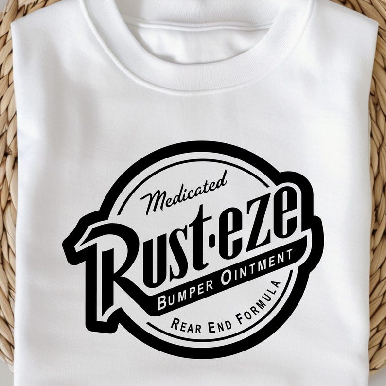 May include: White sweatshirt featuring a black and white graphic. The graphic is a circular design with the words "Medicated Rust-eze Bumper Ointment Rear End Formula" in a vintage style.