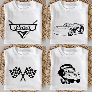 May include: Four white t-shirts with black graphics. One shirt features the "Cars" logo, another Lightning McQueen, a third has crossed checkered flags, and the last shows Tow Mater. The shirts are folded on a woven surface.