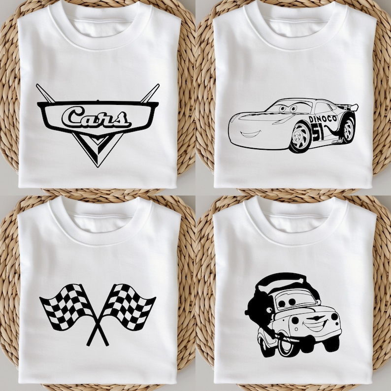 May include: Four white t-shirts with black graphics. One shirt features the "Cars" logo, another Lightning McQueen, a third has crossed checkered flags, and the last shows Tow Mater. The shirts are folded on a woven surface.