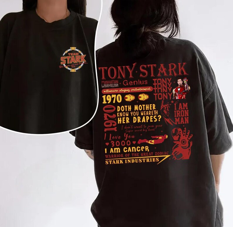 May include: Black t-shirt featuring the text "TONY STARK" and various phrases and graphics in red and white. The front of the shirt has a "TEAM STARK" logo. The shirt is a short-sleeved, casual style.