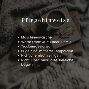 May include: A cozy image featuring a cup of coffee, a notebook, and a candle. The text "Pflegehinweise" is at the top, with bullet points detailing care instructions, including machine wash warm (max. 40&deg;C or 105&deg;F) and do not iron over printed areas.