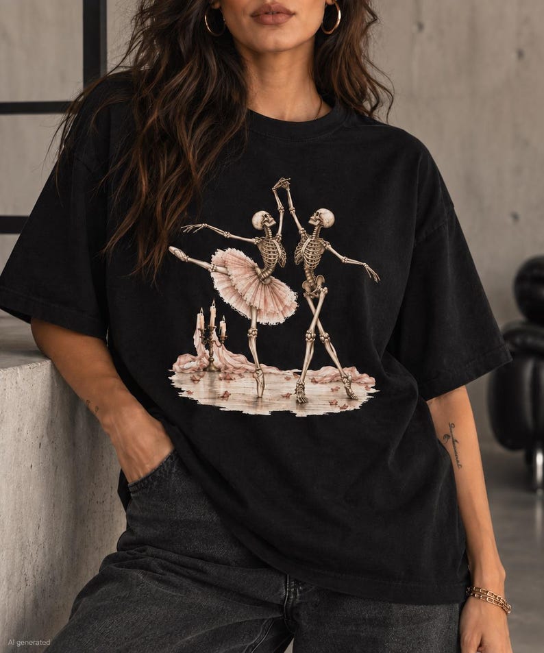 Pu&ograve; includere: Una t-shirt nera con una stampa grafica di due scheletri che ballano. Uno scheletro indossa un tut&ugrave; rosa pallido. La scena include un candelabro con candele accese e petali di rosa sparsi sul terreno, creando un'illustrazione molto dettagliata.