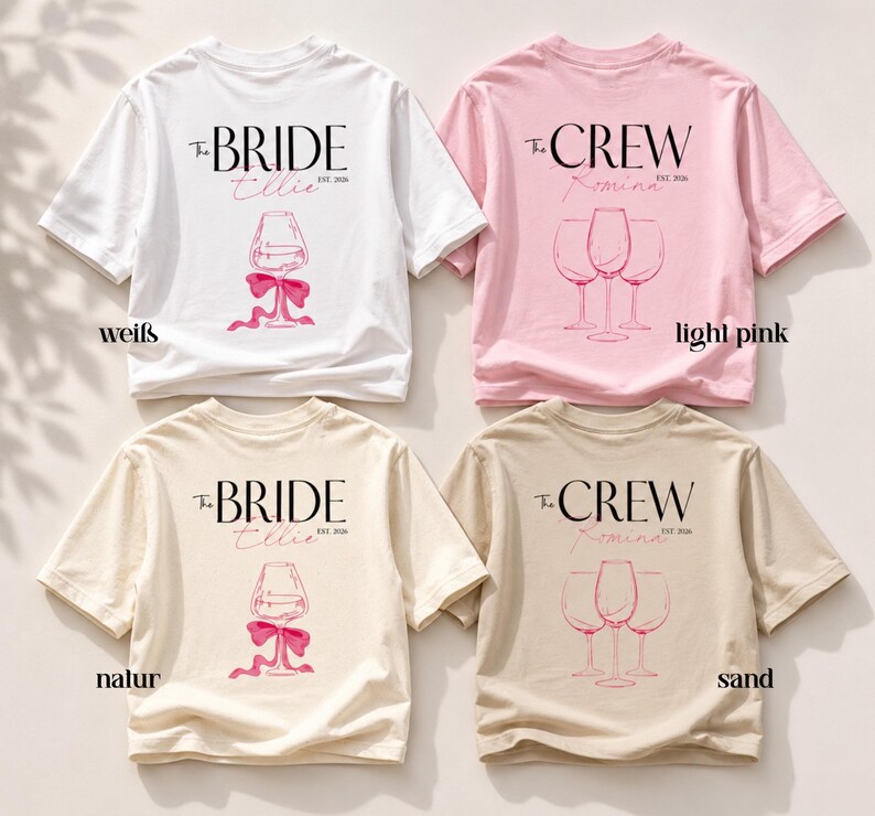May include: Four short-sleeve t-shirts in white, light pink, natural, and sand colors. Each shirt features a graphic print with text reading The BRIDE or The CREW, along with EST. 2026, a name, and a line drawing of either one or three wine glasses.