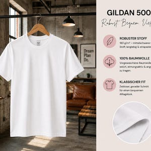 May include: A plain white short-sleeve t-shirt hanging on a wooden hanger. The image includes text detailing the Gildan 5000 model, noting 180 g/m2 fabric weight, 100% cotton composition, and a classic fit, with a circular inset showing fabric texture.