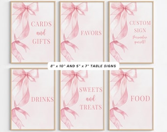 Peut inclure: Ensemble de six panneaux de table encadrés avec un motif de nœud et de ruban rose à l'aquarelle. Le texte comprend "Cadeaux", "Faveurs", "Panneau personnalisé", "Boissons", "Douceurs" et "Nourriture". Panneaux de 20,3 x 25,4 cm et 12,7 x 17,8 cm.
