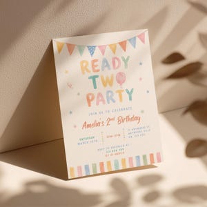 May include: A pastel-colored birthday party invitation with the text "READY TWO PARTY" and "Amelia's 2nd Birthday". The invitation includes details such as the date, time, and location, with a banner of colorful flags at the top.