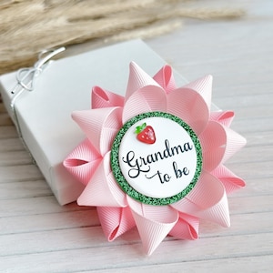May include: Pink and green bow with a white circle that says "Grandma to be" and a red strawberry graphic.