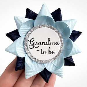 Boy baby shower pin made of light blue and navy blue ribbon with silver accent and custom text: Grandma to be