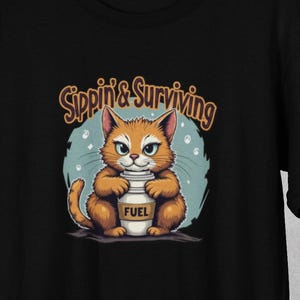 Sippin&#39; & Surviving - Funny Cat Coffee T-Shirt, Caffeine Humor Shirt, Gift for Cat Lover, Animal Lover Apparel, Coffee Lover Birthday Gifts