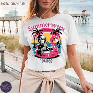 May include: White t-shirt with a colorful graphic featuring a skeleton in a Grim Reaper robe, sunglasses, and a cocktail, floating on a pink flamingo float. The text "Summerween Vibes" is above the graphic.