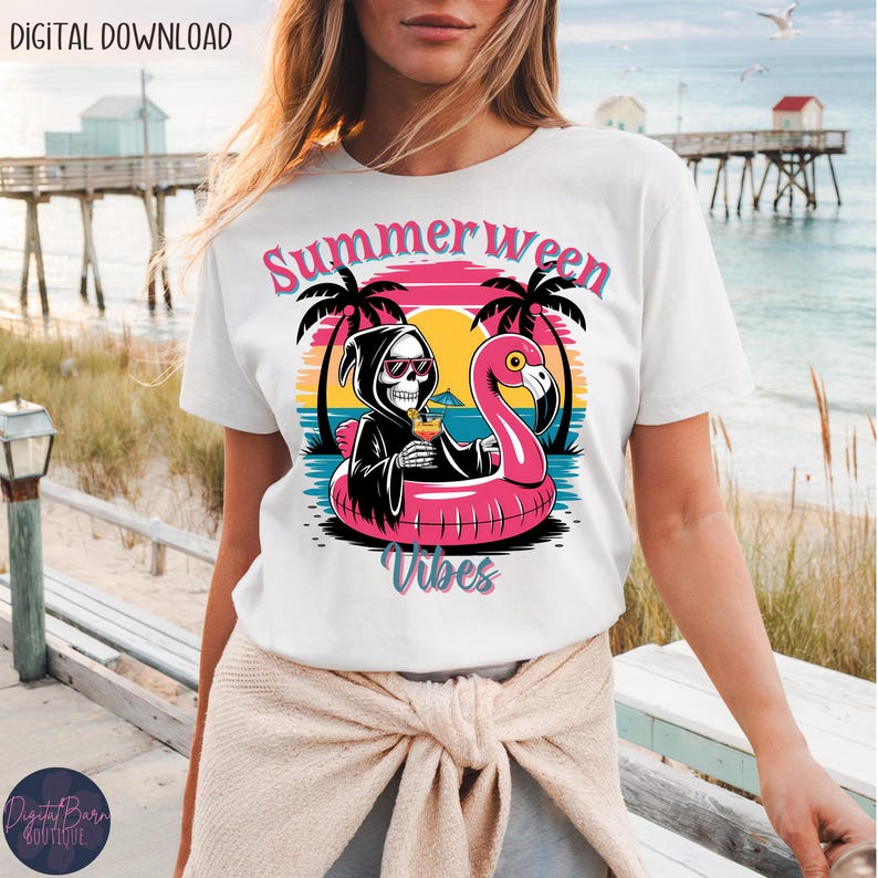May include: White t-shirt with a colorful graphic featuring a skeleton in a Grim Reaper robe, sunglasses, and a cocktail, floating on a pink flamingo float. The text "Summerween Vibes" is above the graphic.
