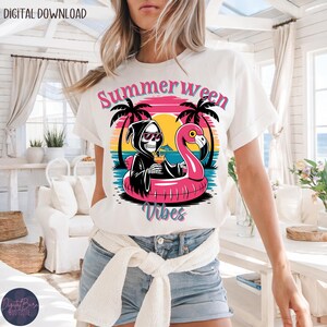 May include: White t-shirt with a colorful graphic featuring a Grim Reaper character in a black robe, sunglasses, and a cocktail, floating on a pink flamingo float. The text "Summerween Vibes" is above and below the graphic.